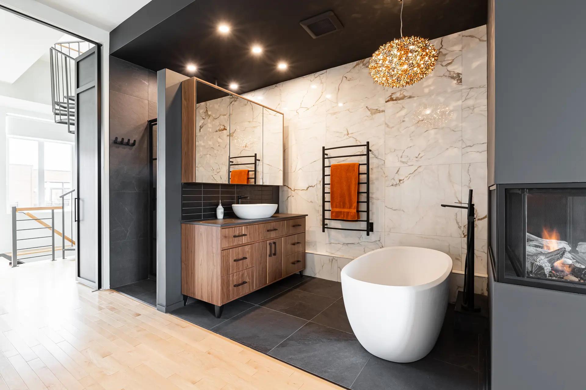 Contemporary bathroom with a freestanding bathtub and walk-in shower, wood flooring, and marble tiles